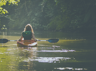 woman kayaking down a river